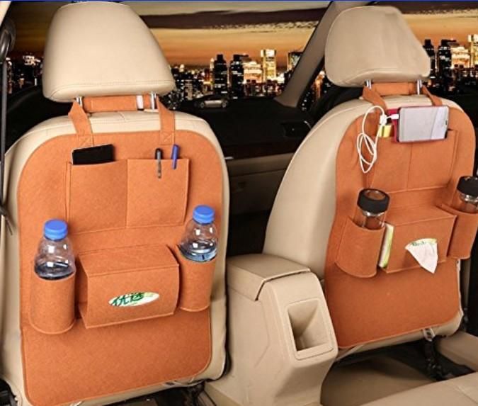 Car seat back organizers with various items in a vehicle interior.