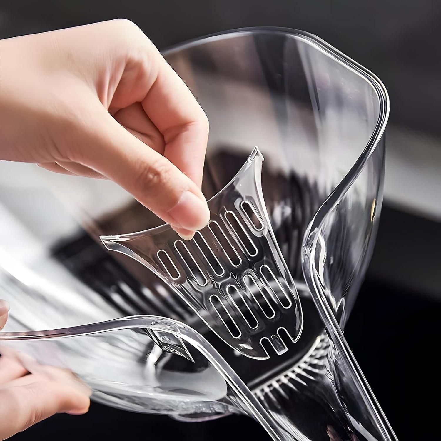 Clear plastic strainer held by a hand over a glass container
