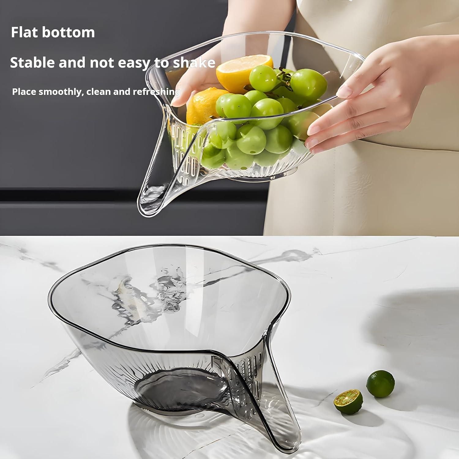 Clear fruit bowl with fruits being held above it, placed on a marble surface.