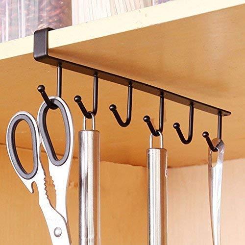Hanging kitchen utensil holder with hooks on a wooden surface