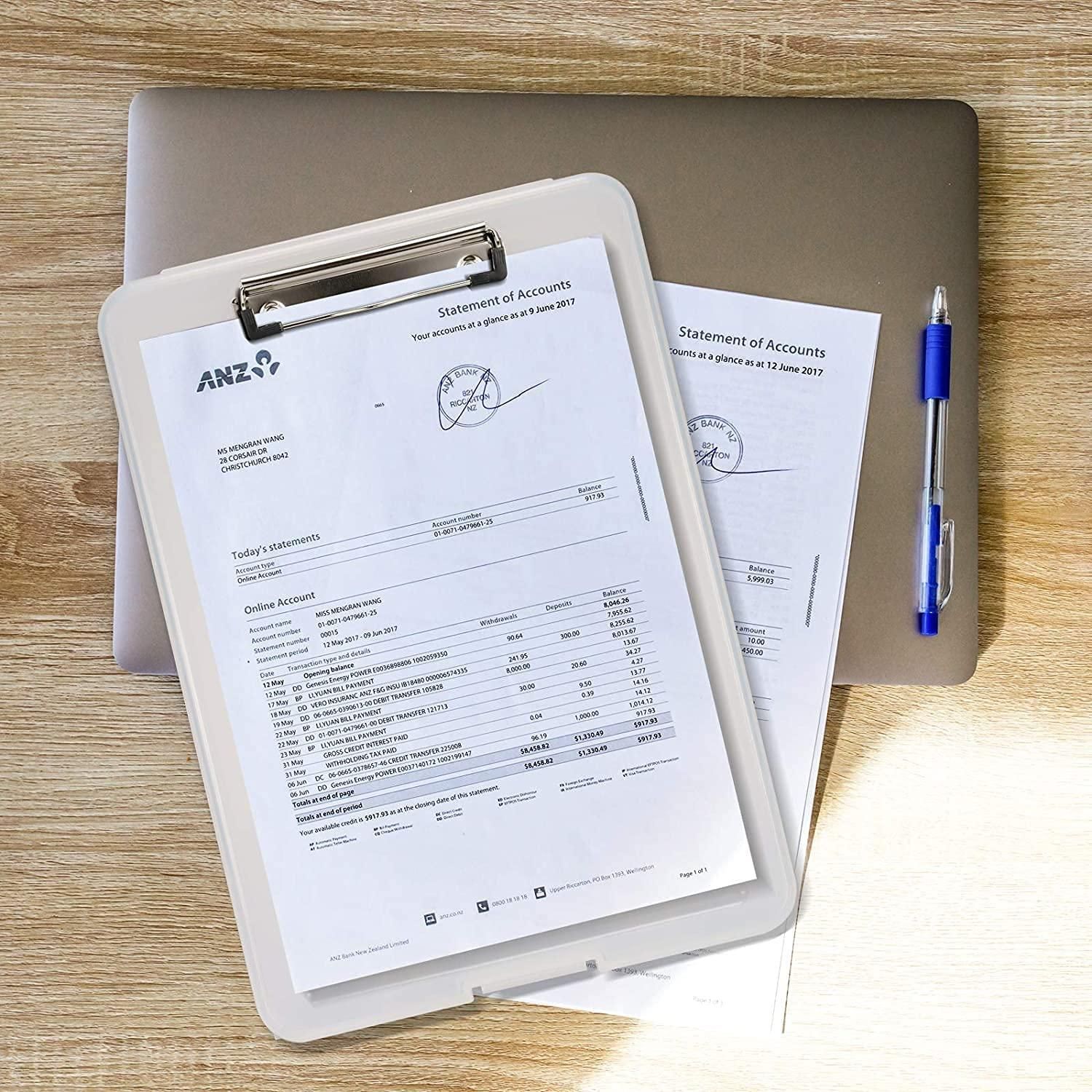 Clipboard with ANZ statement of accounts on a wooden surface